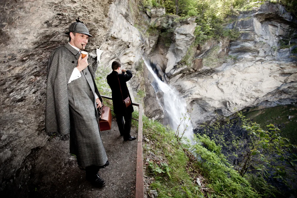 The Reichenbach Falls, with a figure in a deerstalker on the viewing path