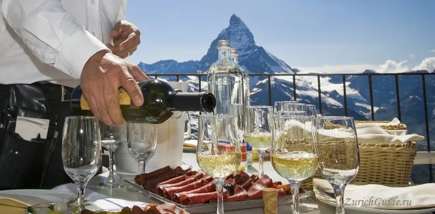 White wine poured on a terrace with the Matterhorn behind